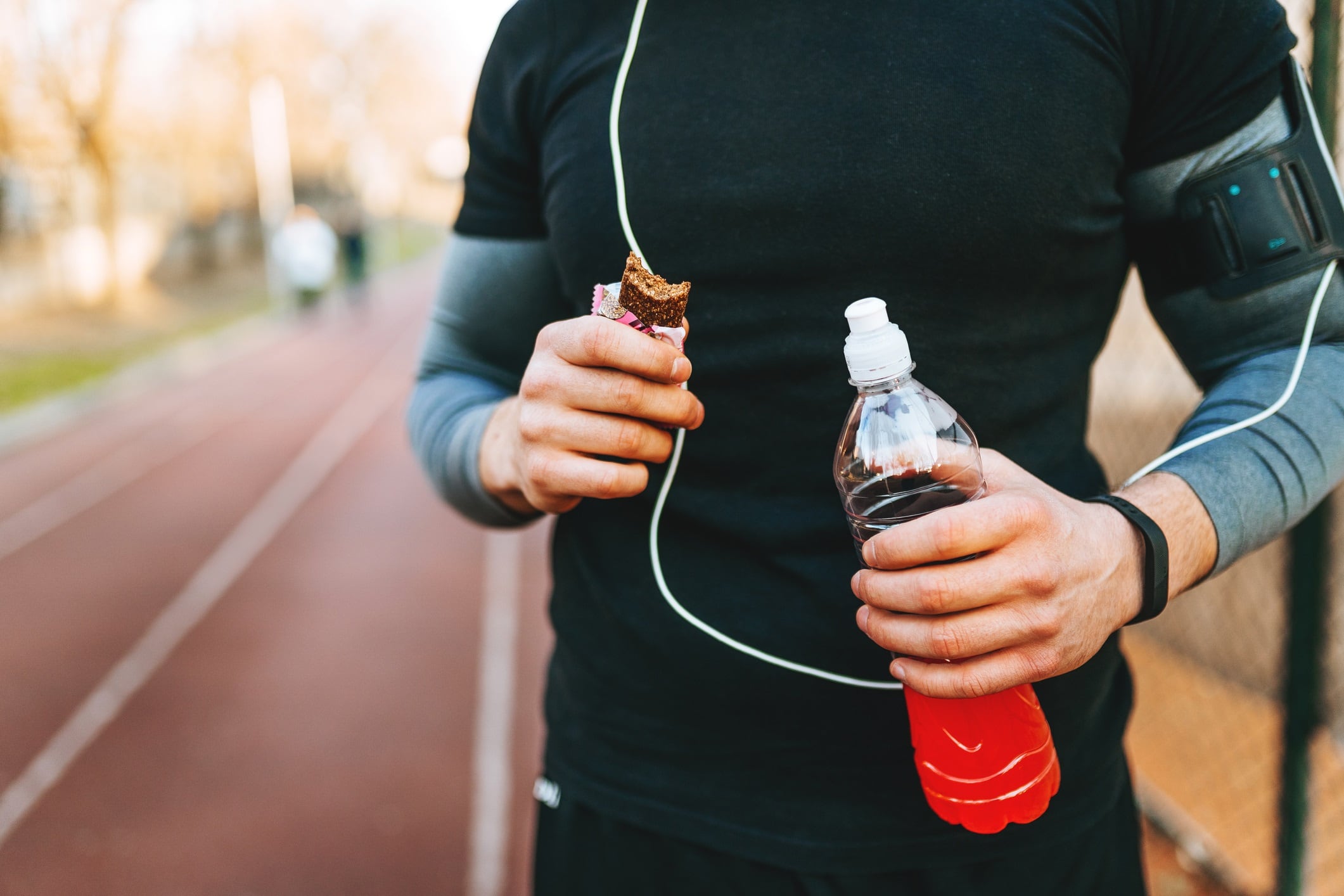 Man exercising and lives healthy life.
Protein bar and energy drink