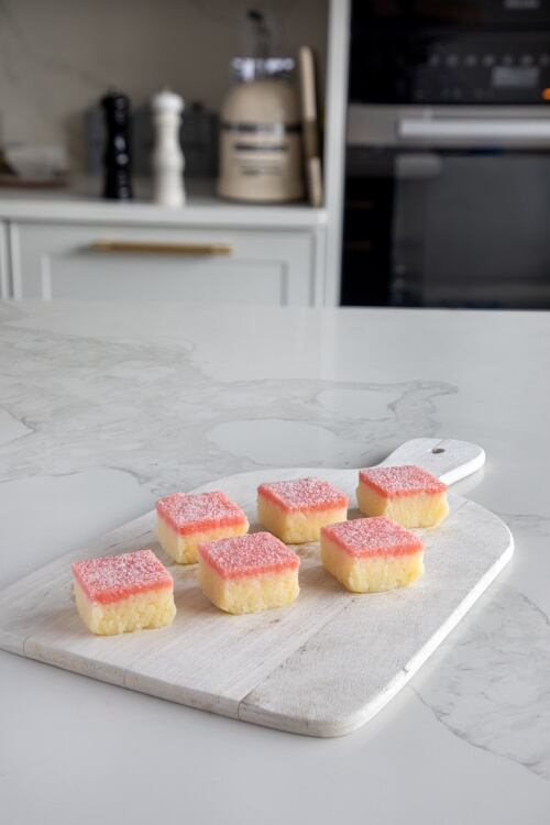 Coconut Burfi combines grated coconut, milk and sugar to create a dense, mildly sweet confection.