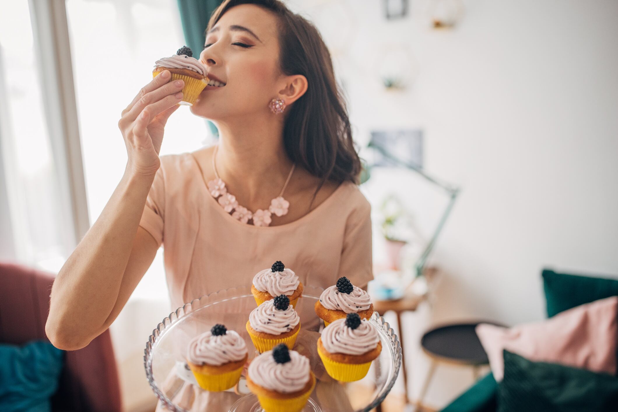 Woman eating a cupcake