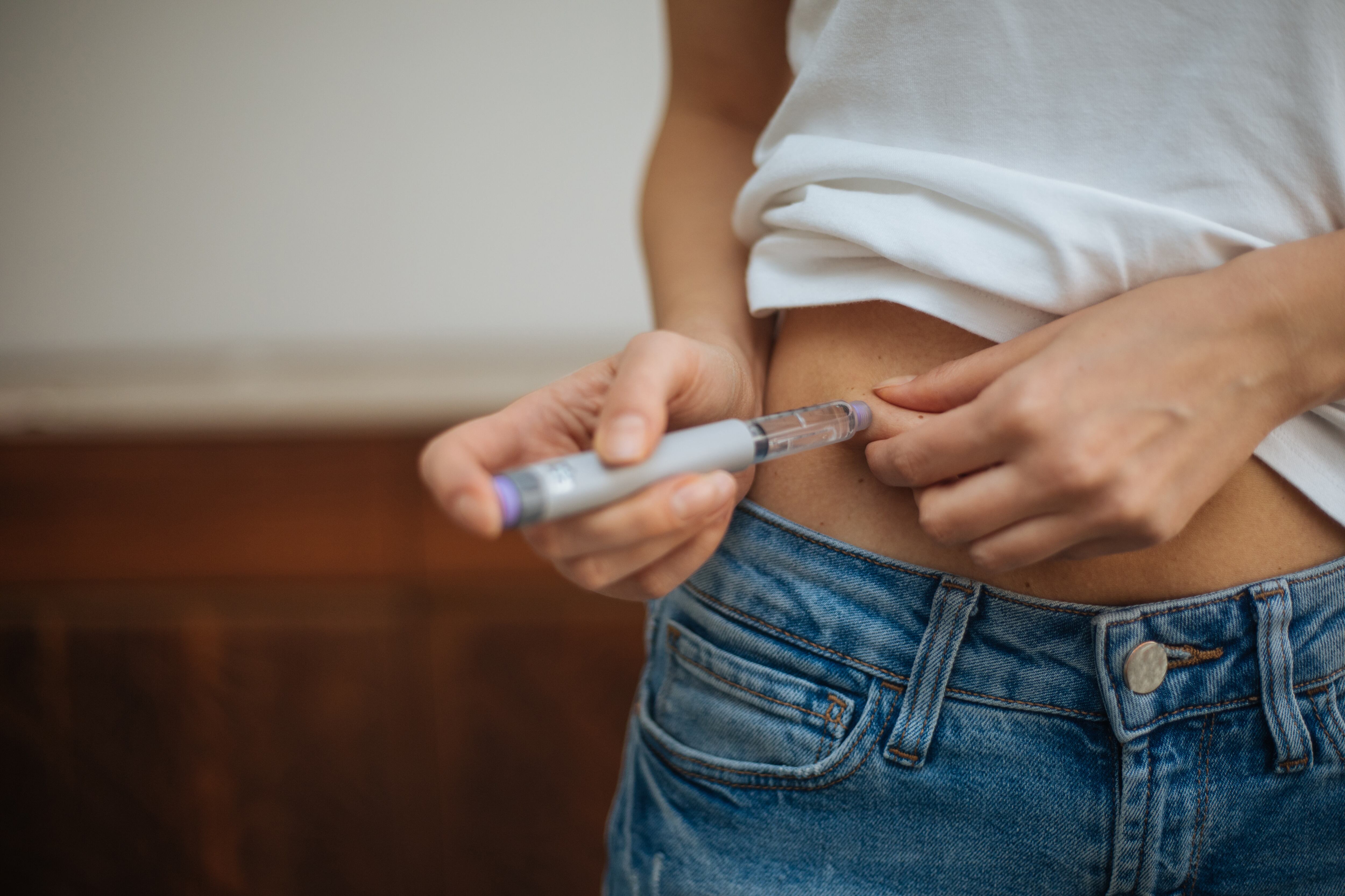 Woman injecting weight-loss drug