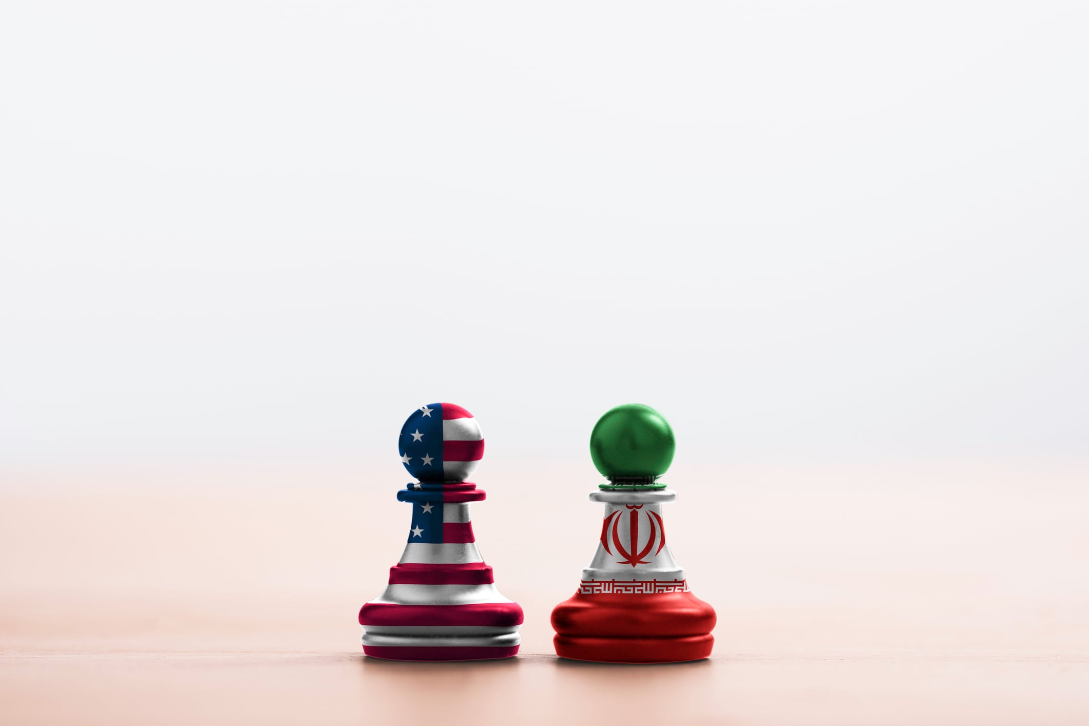 USA flag and Iran flag print screen on pawn chess with soft light background.It is symbol of United state of America and Iran have conflict in nuclear weapons and Strait of Hormuz.