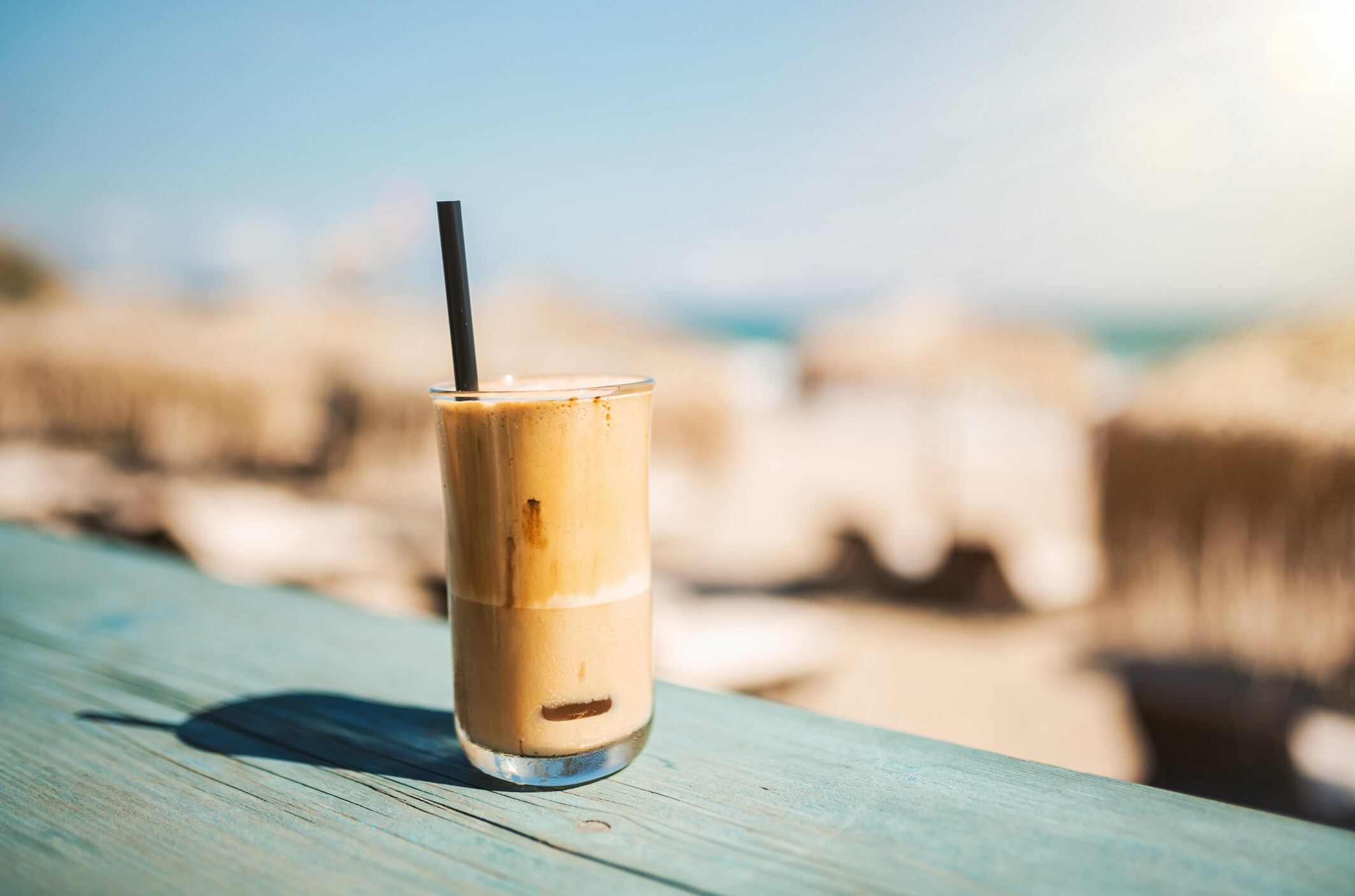 Summer, vacation and iced coffee frappe at the beach