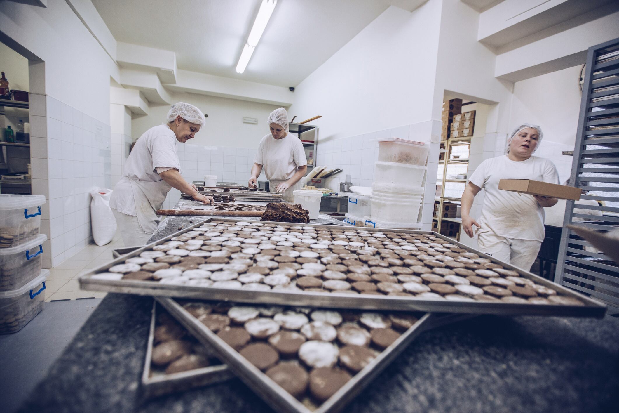 Women making cookies in small factory